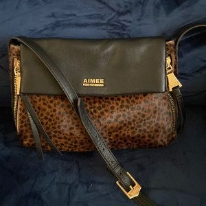 “Black leather Animal print in front is very soft. No scuffs or markings